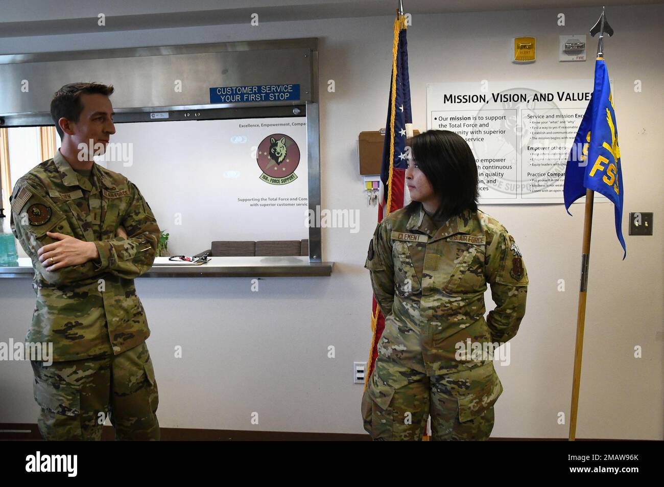 Airman Miranda Clement(Right) of the 168th Wing, 168th Force Support Squadron, 168th Services Flight was promoted to Airman during the June drill in the Alaska Air National Guard. A ceremony was held to celebrate her accomplishments and Clement's Services Flight commander(left) said a few words during the ceremony. The Force Support Squadron Services provides quality of life to the Wing's members and their families performing duties to keep our unit operational, including fitness, feeding Airmen, lodging, mortuary affairs, and the management and accounting procedures needed to support the miss Stock Photo