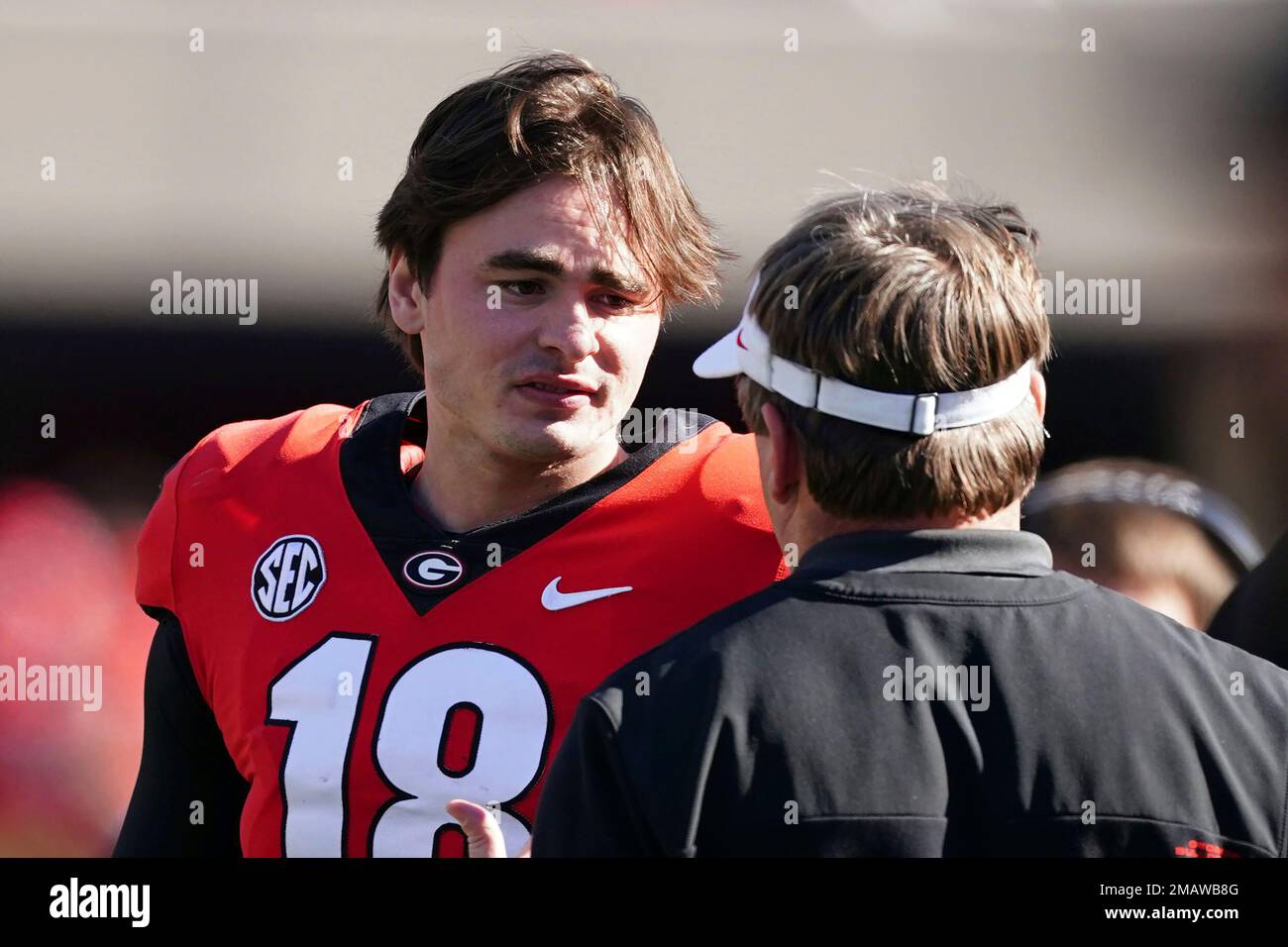 FILE quarterback JT Daniels (18) talks with head coach Kirby