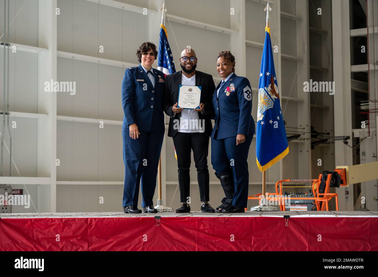 Col. Kerya Reyes, commander, Detachment 5, Headquarters Individual Reservist Readiness and Integration Organization; 911th Airlift Wing Command Chief Master Sgt. Jamesha Barnes; and Barnes’s husband, Jay Adams, pose for a photo at Pittsburgh International Airport Air Reserve Station, Pennsylvania, June 5, 2022. The certificate of appreciation is to recognize Adams for his continued support during his wife’s service. Stock Photo