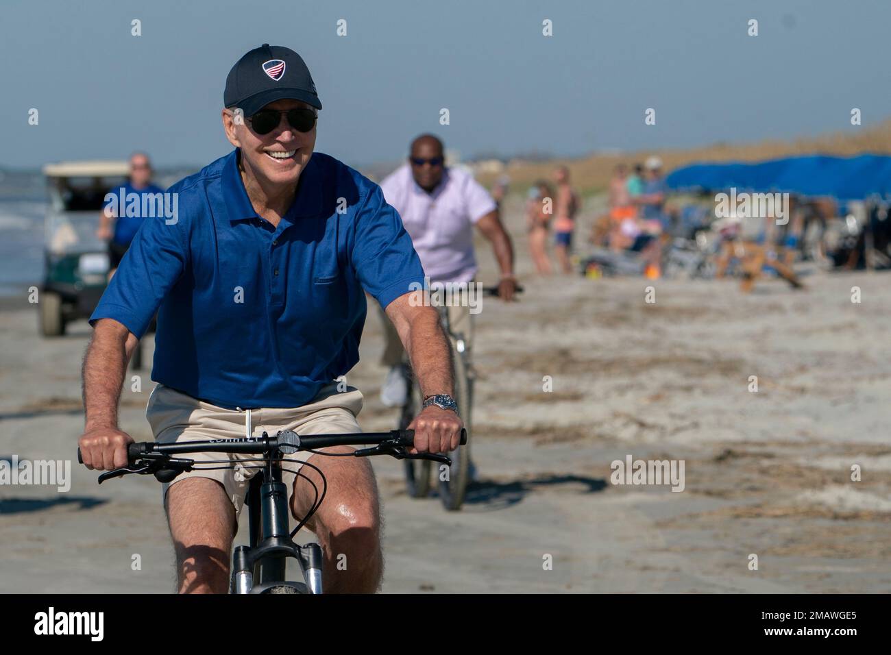 President Joe Biden rides a bicycle along the beach at Kiawah Island, S(01)