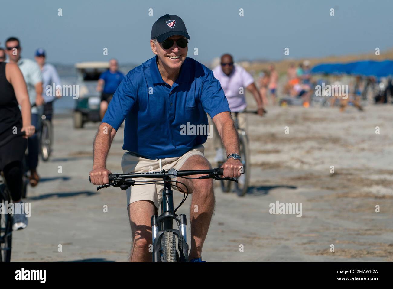 President Joe Biden rides a bicycle along the beach at Kiawah Island, S