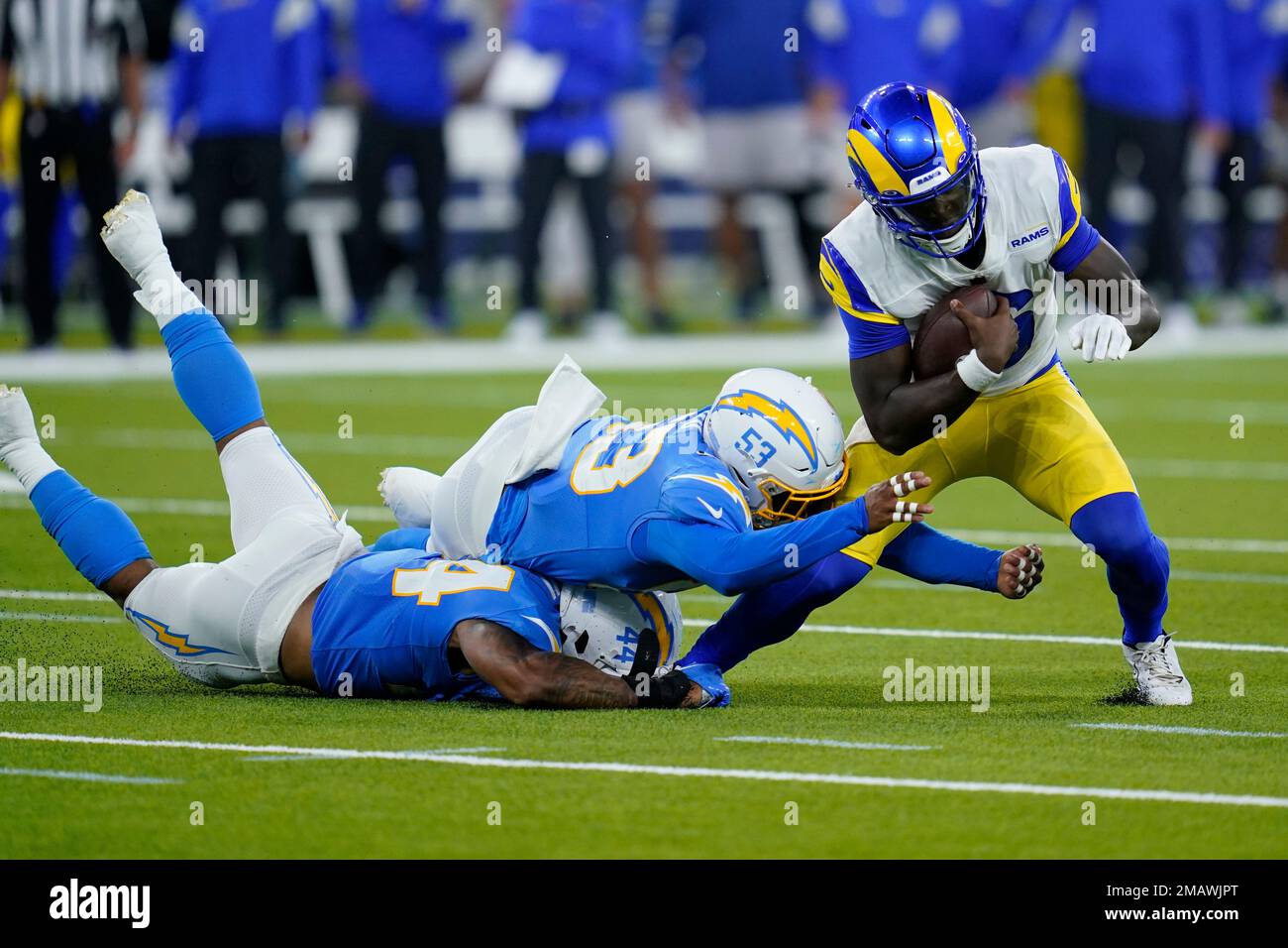 Los Angeles Rams quarterback Bryce Perkins, right, is tackled by Los  Angeles Chargers linebacker Jamal Davis II, bottom, and linebacker Damon  Lloyd (53) during the second half of a preseason NFL football