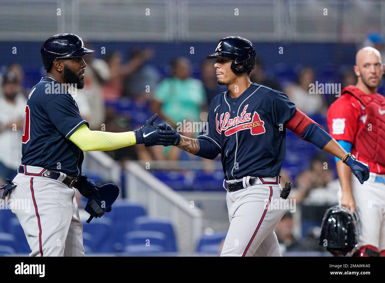 Atlanta Braves' Marcell Ozuna, left, congratulates Vaughn Grissom after  Grissom hit a home run scoring Ozuna during the fifth inning of the second  game of a baseball doubleheader against the Miami Marlins