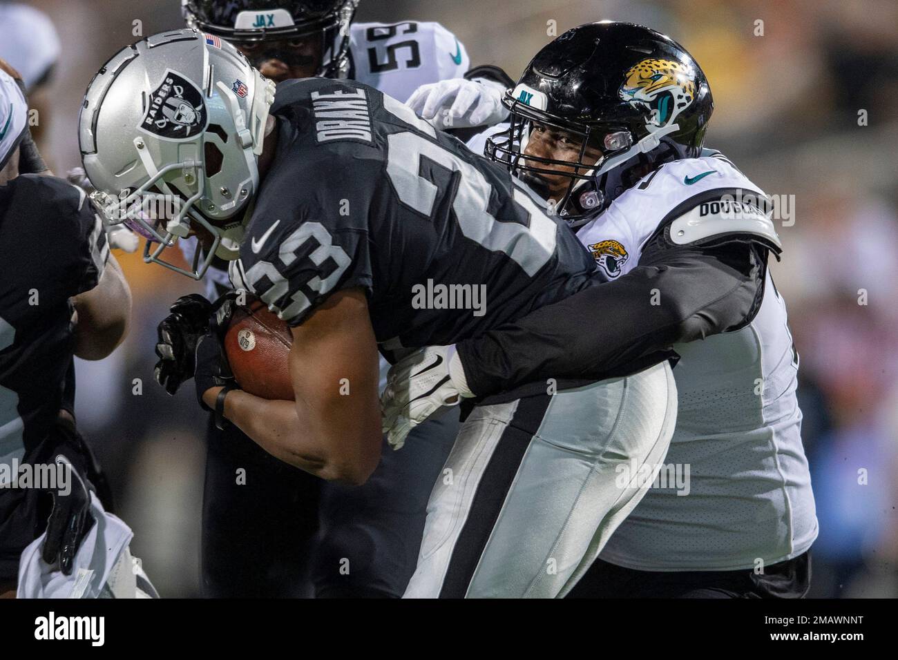 Jacksonville Jaguars defensive tackle Raequan Williams tackles Las Vegas  Raiders running back Kenyan Drake during the first half of the NFL football  exhibition Hall of Fame Game, Thursday, Aug. 4, 2022, in