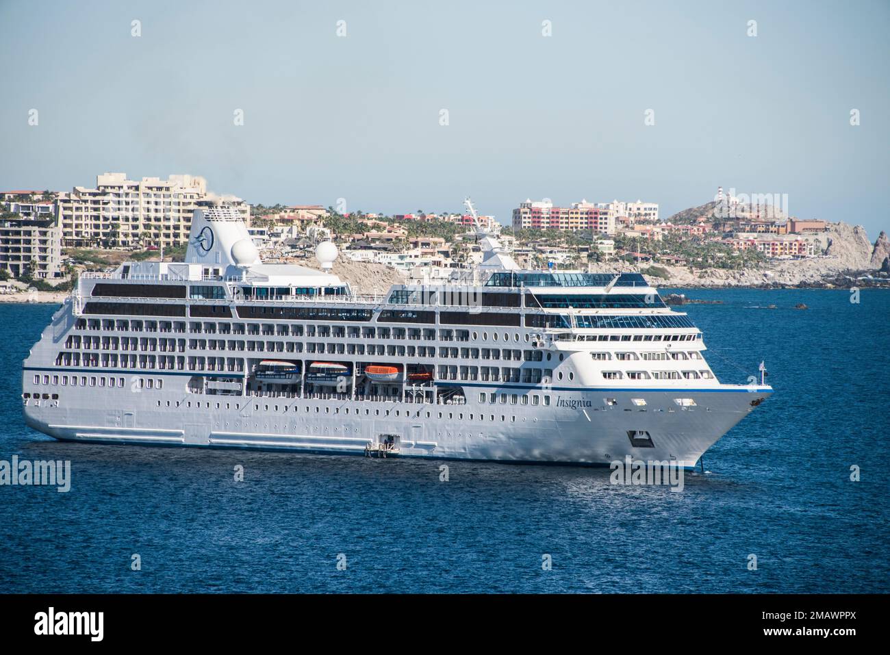A cruise ship lays at anchor in the port of Cabo San Lucas, Mexican ...