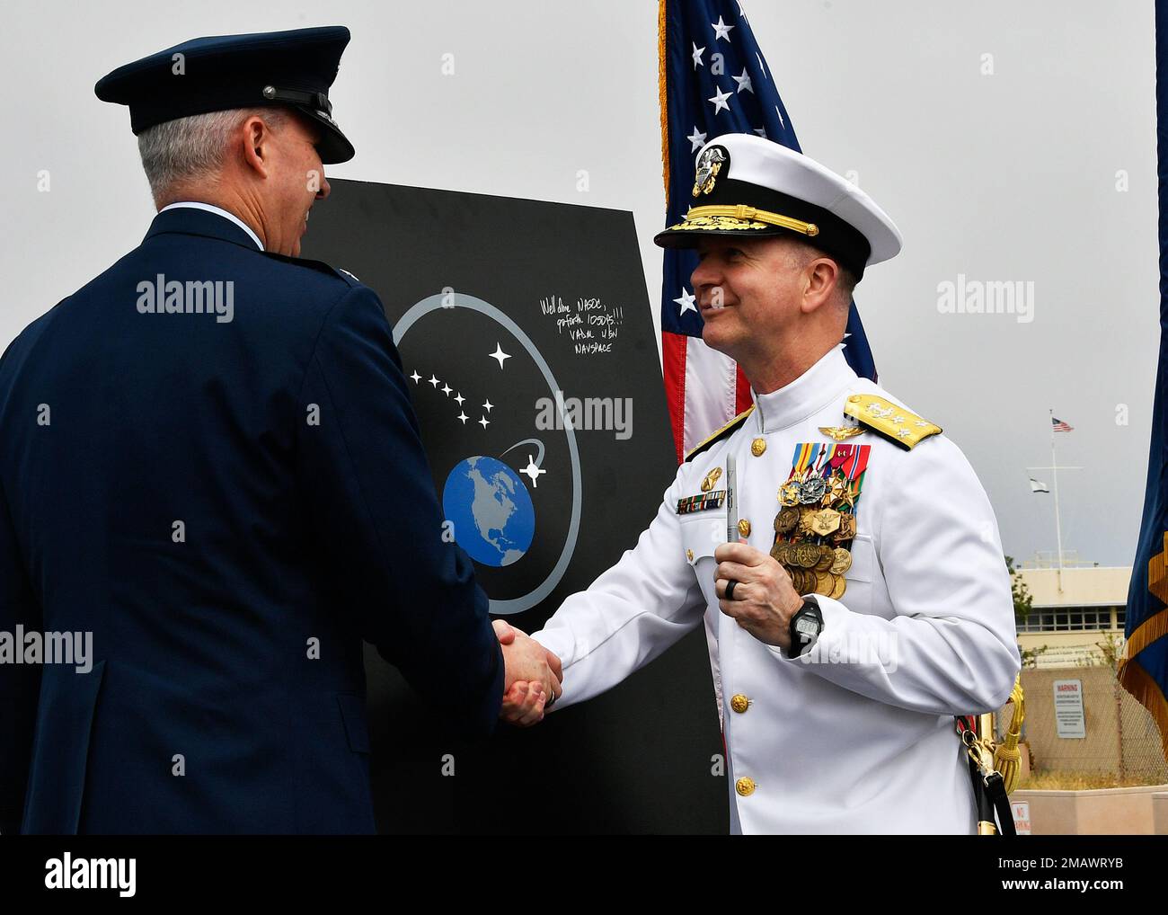 220606-N-AS200-5008 POINT MUGU, Calif. (Jun. 6, 2022) - Vice Adm. Ross Myers, commander, U.S. Fleet Cyber Command / U.S. 10th Fleet, left shakes hands with U.S. Space Force Lt. Gen. Stephen Whiting, commander, Space Operations Command, during the Naval Satellite Operations Center (NAVSOC) disestablishment ceremony onboard Naval Base Ventura County (NBVC) Jun. 6. NBVC is a strategically located Naval installation composed of three operating facilities: Point Mugu, Port Hueneme and San Nicolas Island. NBVC is the home of the Pacific Seabees, West Coast E-2C Hawkeyes, 3 warfare centers and 80 ten Stock Photo