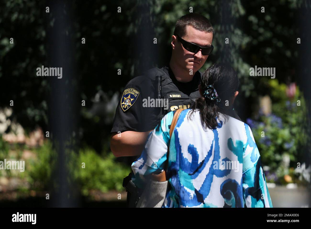 An officer with the Chautauqua Sheriffs Department speaks to a person at the Chautauqua Institution in Chautauqua, N.Y., Friday,