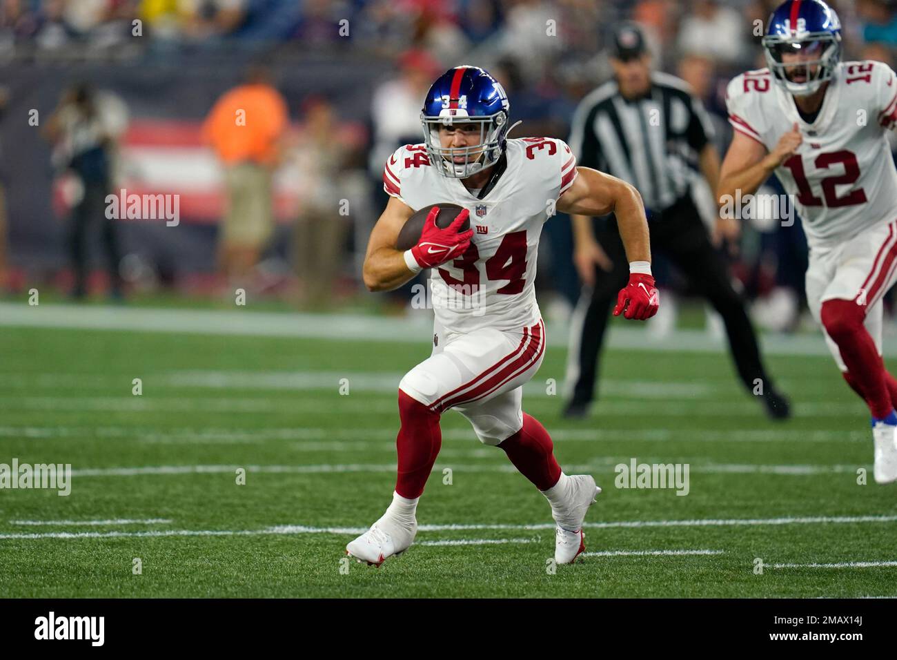New York Giants running back Sandro Platzgummer (34) runs with the ball  during the second half on a preseason NFL football game against the New  England Patriots, Thursday, Aug. 11, 2022, in