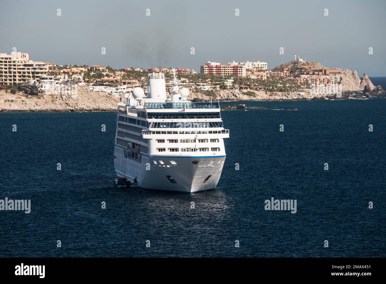 A cruise ship lays at anchor in the port of Cabo San Lucas, Mexican ...