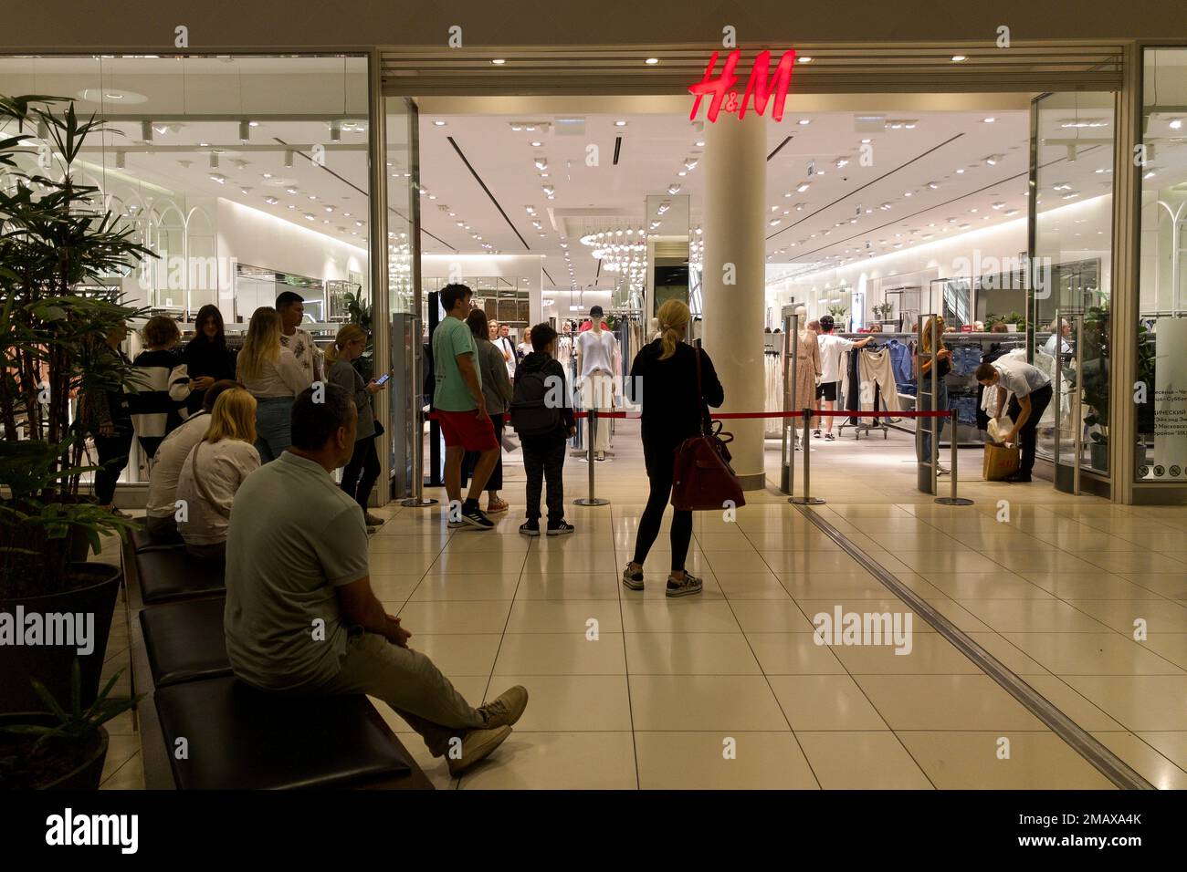 People line up to enter an H&M shop and buy items on sale in the Aviapark  shopping mall in Moscow, Russia, Tuesday, Aug. 9, 2022. Russians are  snapping up Western fashion and