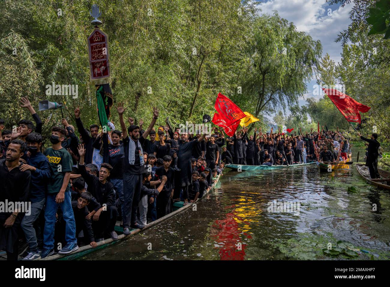 Kashmiri Shiite Muslims shout religious slogans as they participate in ...