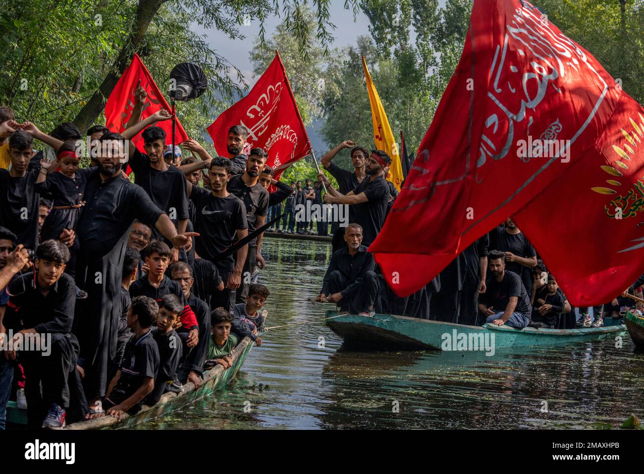 Kashmiri Shiite Muslims shout religious slogans as they participate in ...