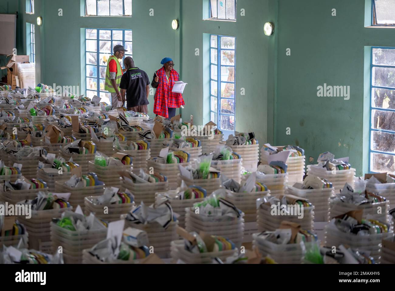 An electoral worker walks past ballot boxes and election materials as