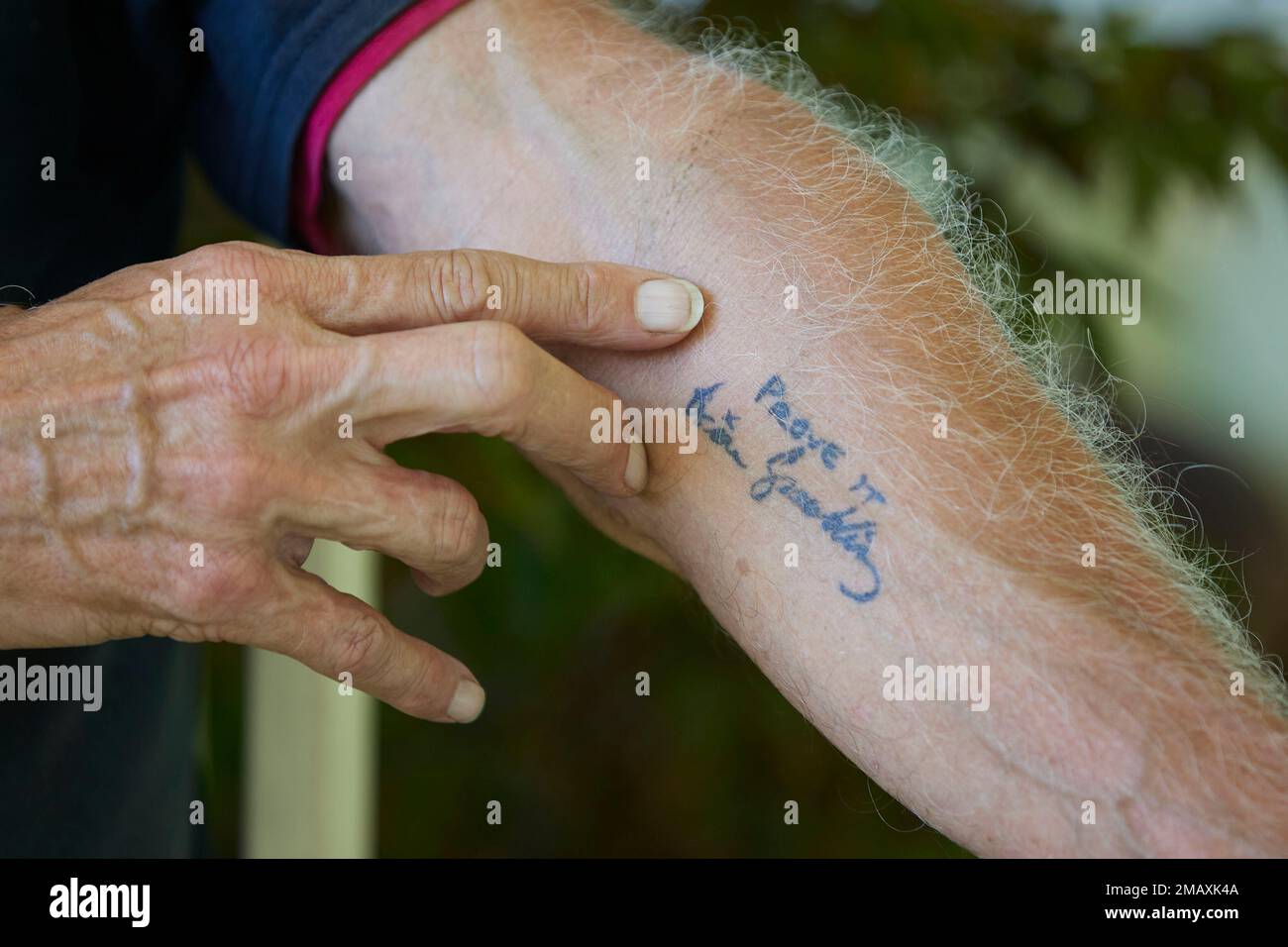 George Spaulding shows his tattoo of one of the favorite phrases of his ...