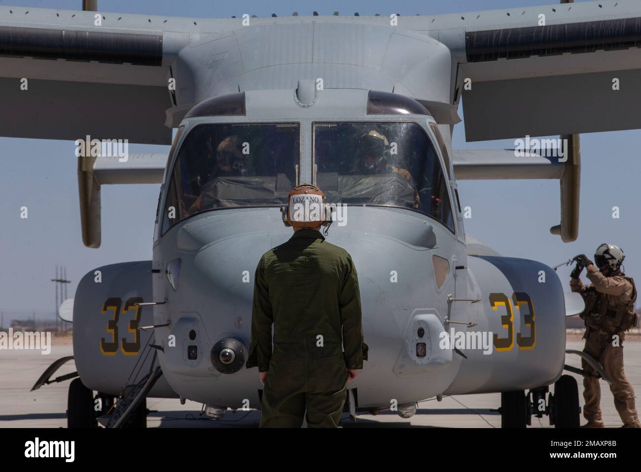 U.S. Marine Corps Lance Cpl. Tyler Torpy, a tiltrotor mechanic with Marine Medium Tiltrotor Squadron (VMM) 362 (Reinforced), 13th Marine Expeditionary Unit, prepares to guide a MV-22B Osprey during Realistic Urban Training exercise at Marine Corps Air Station Yuma, Arizona, June 7, 2022. The purpose of RUT is to enhance the integration and collective capability of the MEU's command air, ground and logistics elements and prepare the 13th MEU to meet the nation's crisis response needs during its upcoming overseas deployment. Stock Photo