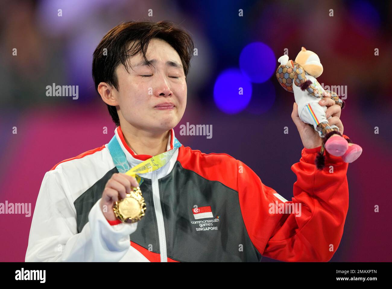 Gold medalist Singapore's Tianwei Feng poses with her medal in the