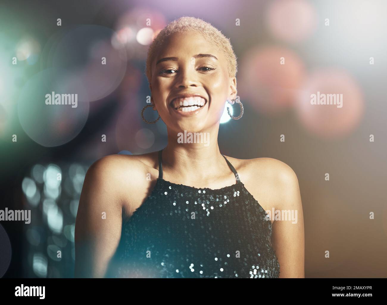 Portrait, happy woman and face with glitter and disco, party girl in night club with happiness and bokeh overlay. Celebration with dancing, smile and Stock Photo