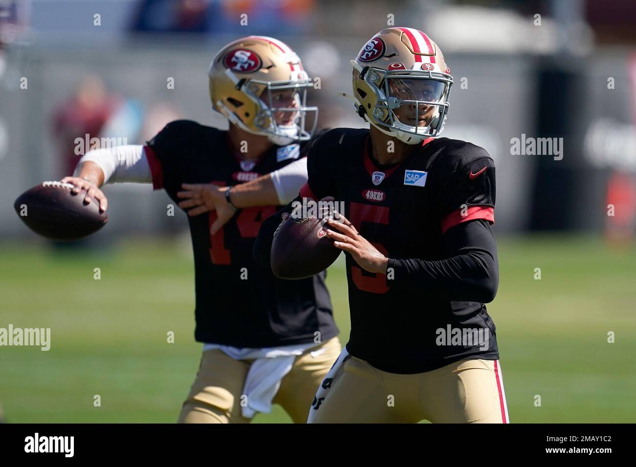 San Francisco 49ers quarterbacks Trey Lance (5) and Brock Purdy take part  in drills at the NFL football team's practice facility in Santa Clara,  Calif., Friday, Aug. 5, 2022. (AP Photo/Jeff Chiu