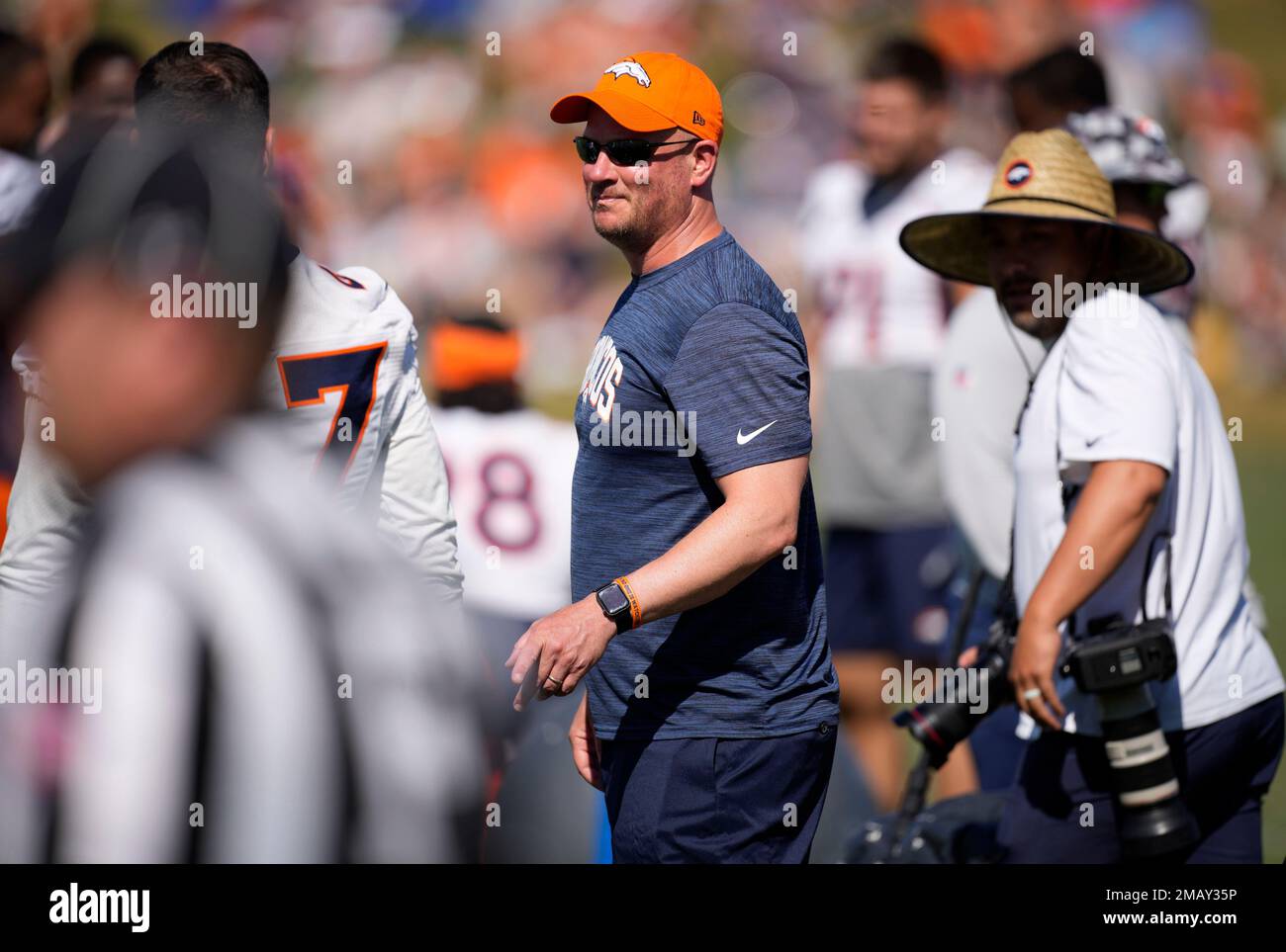 Denver Broncos head coach Nathaniel Hackett jokes with players as they