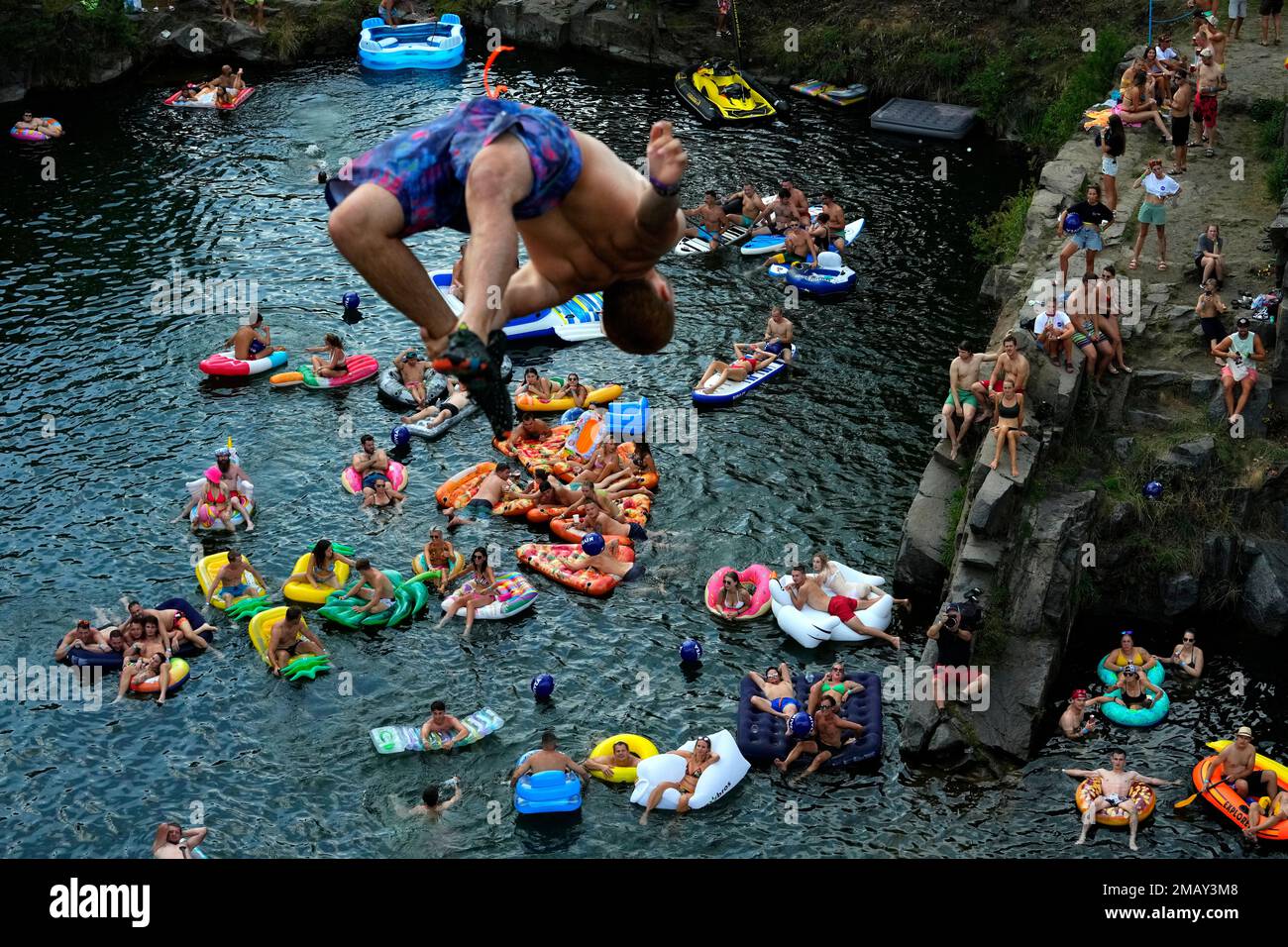 A diver jumps into water during a high diving competition near the