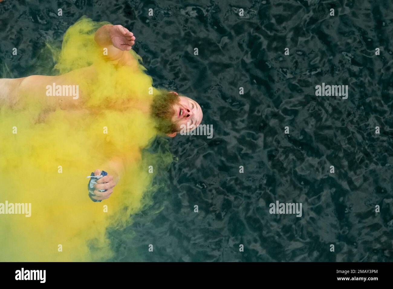 A diver jumps into water during a high diving competition near the