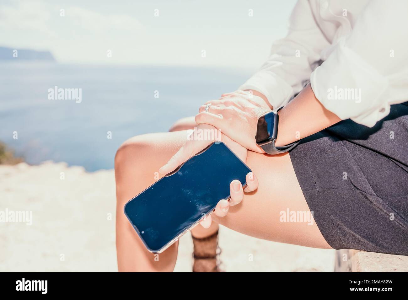 Woman sea laptop. Business woman in yellow hat freelancer with laptop working over blue sea beach. Girl relieves stress from work. Freelance, digital Stock Photo