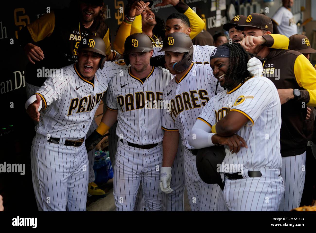 San Diego Padres teammates take a picture in the dugout after a grand slam  by Brandon Drury, second from right, below, during the first inning of a  baseball game against the Colorado