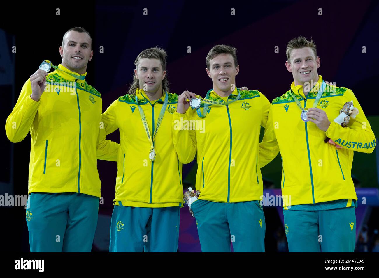 Team Australia swimmers pose after winning the silver medal in the Men