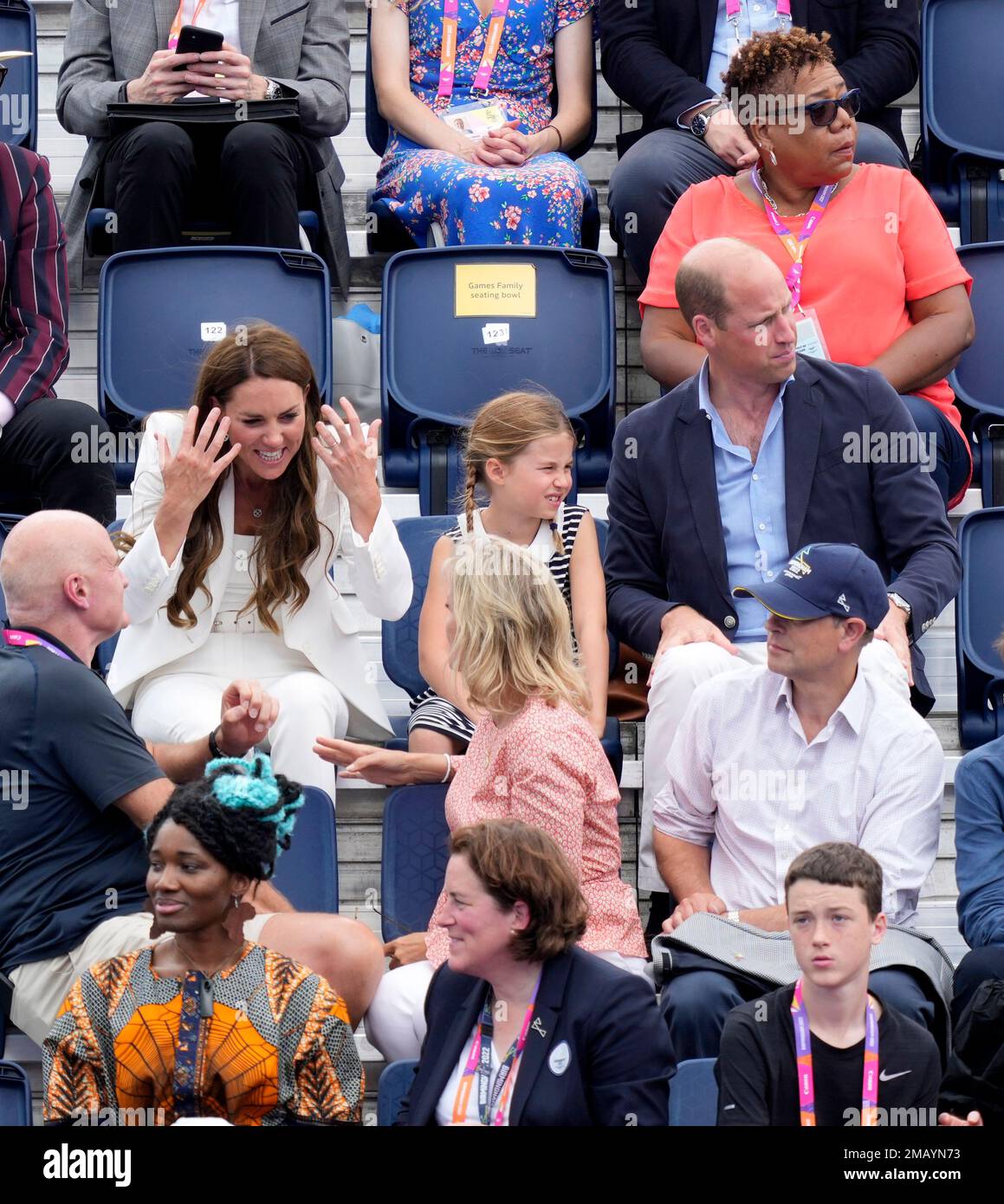 Kate, Duchess of Cambridge, interacts with spectators, as Britains Prince William and Princess Charlotte watch the Womens Pool A hockey match between India and England at the Commonwealth Games in Birmingham, England,