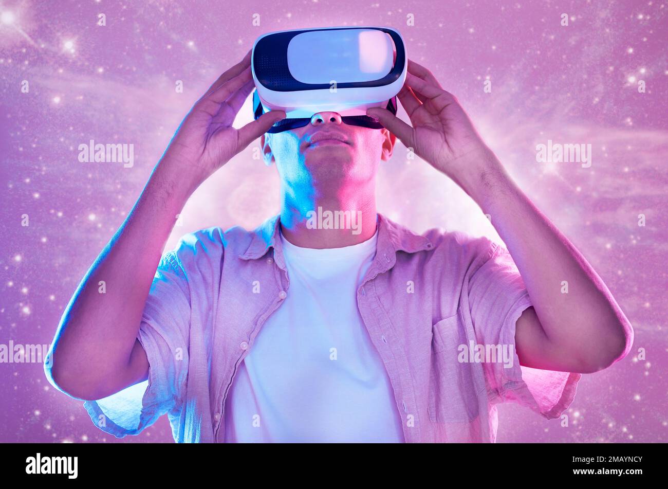 Futuristic, virtual reality and man in universe space on 3d technology headset. Vr metaverse, pink neon and male exploring a future cyber galaxy Stock Photo