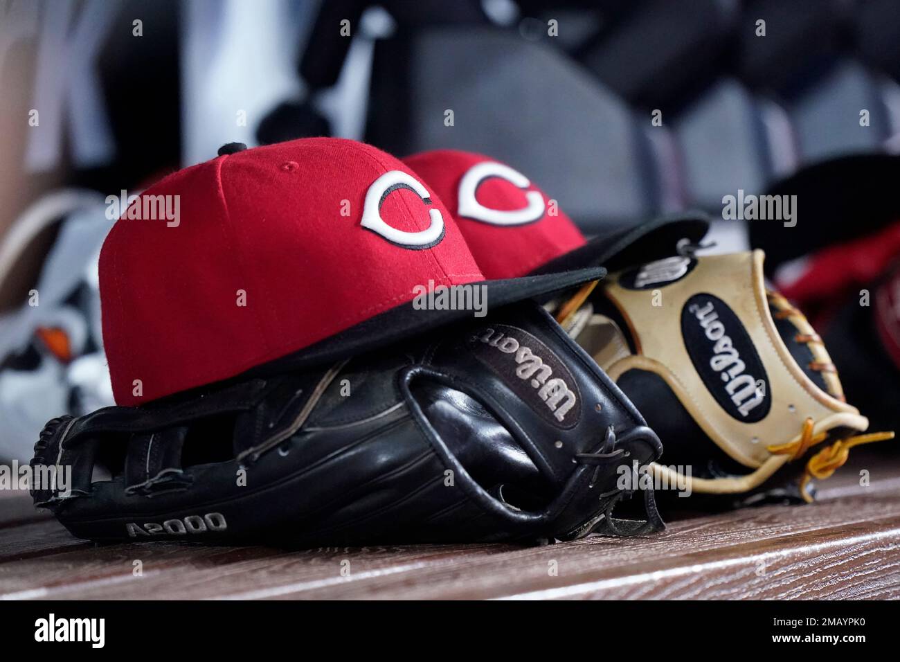 Baseball caps and gloves are shown in the visitor's dugout during the fourth inning of a