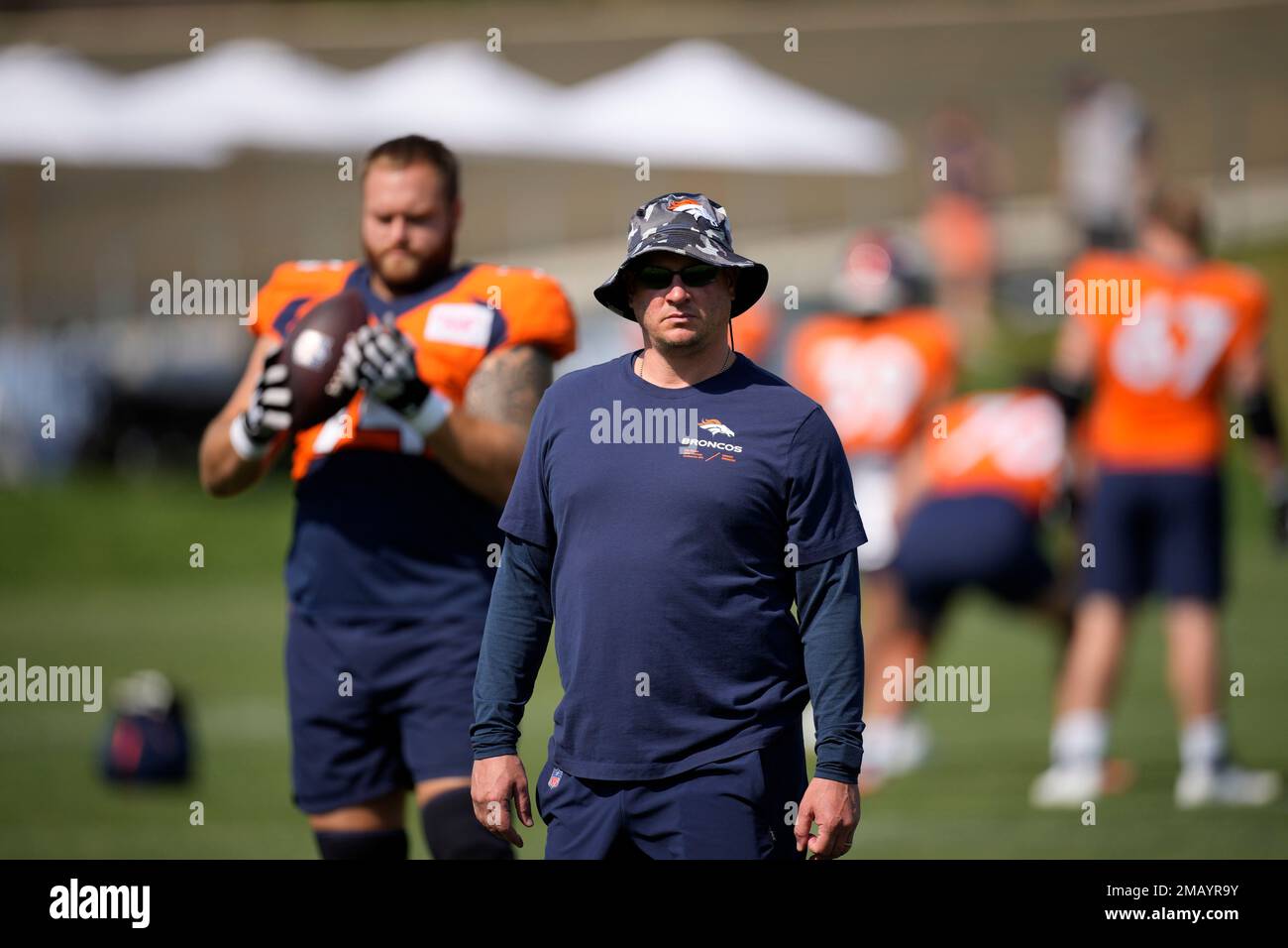 Denver Broncos head coach Nathaniel Hackett takes part in drills during