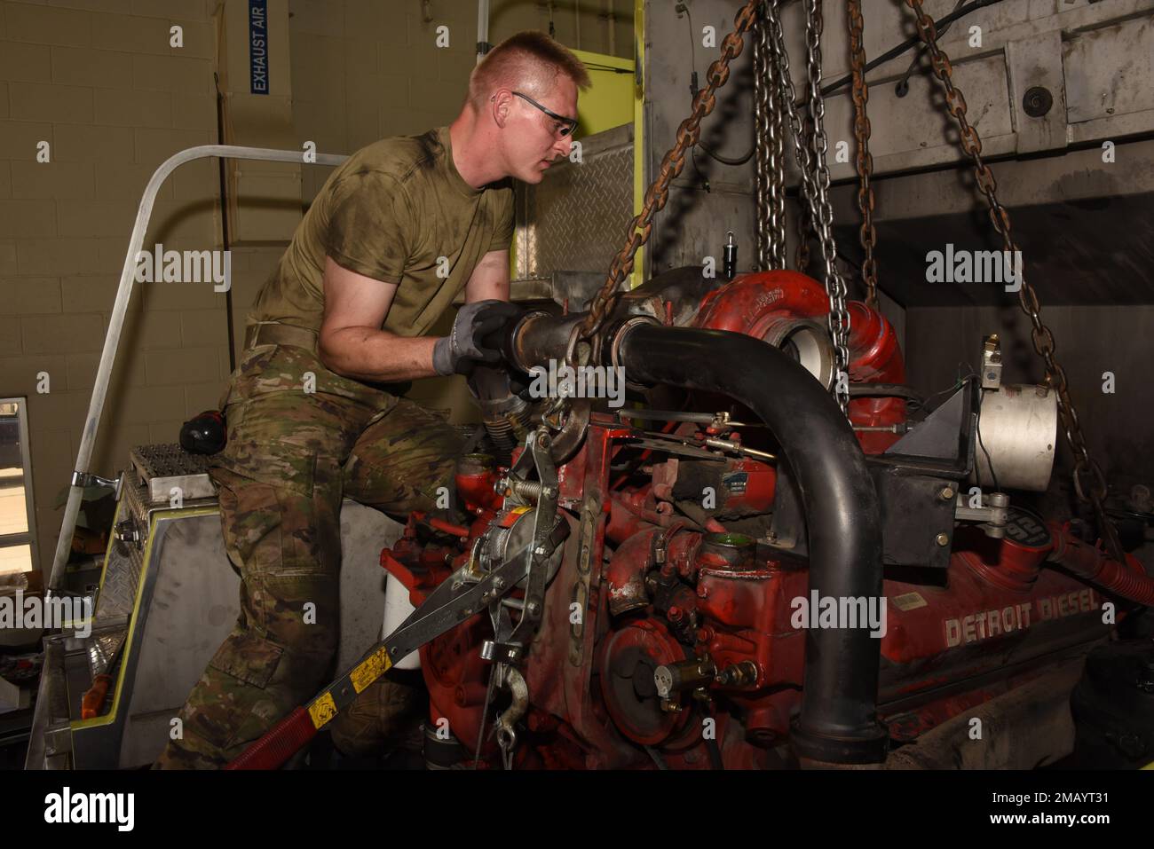 185th Air Refueling Wing vehicle mechanic Technical Sgt. Jason Lammers works to remove an 8 cylinder Detroit Diesel engine from the rear of a 1996 Teledyne P23 “Crash Truck” at the 185th Air Refueling Wing vehicle maintenance shop in Sioux City, Iowa on June 8, 2022. 185th ARW mechanics are overhauling the engine because it had developed an internal coolant leak.    U.S. Air National Guard photo Senior Master Sgt. Vincent De Groot Stock Photo
