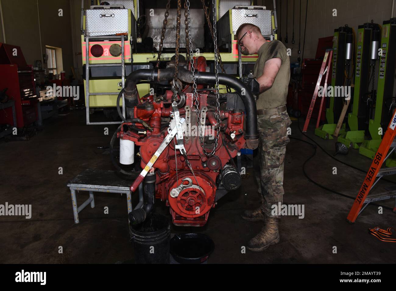 185th Air Refueling Wing vehicle mechanic Technical Sgt. Jason Lammers works on an 8 cylinder Detroit Diesel engine after removing it from the rear of a 1996 Teledyne P23 “Crash Truck” at the 185th Air Refueling Wing vehicle maintenance shop in Sioux City, Iowa on June 8, 2022. 185th ARW mechanics are overhauling the engine because it had developed an internal coolant leak.    U.S. Air National Guard photo Senior Master Sgt. Vincent De Groot Stock Photo