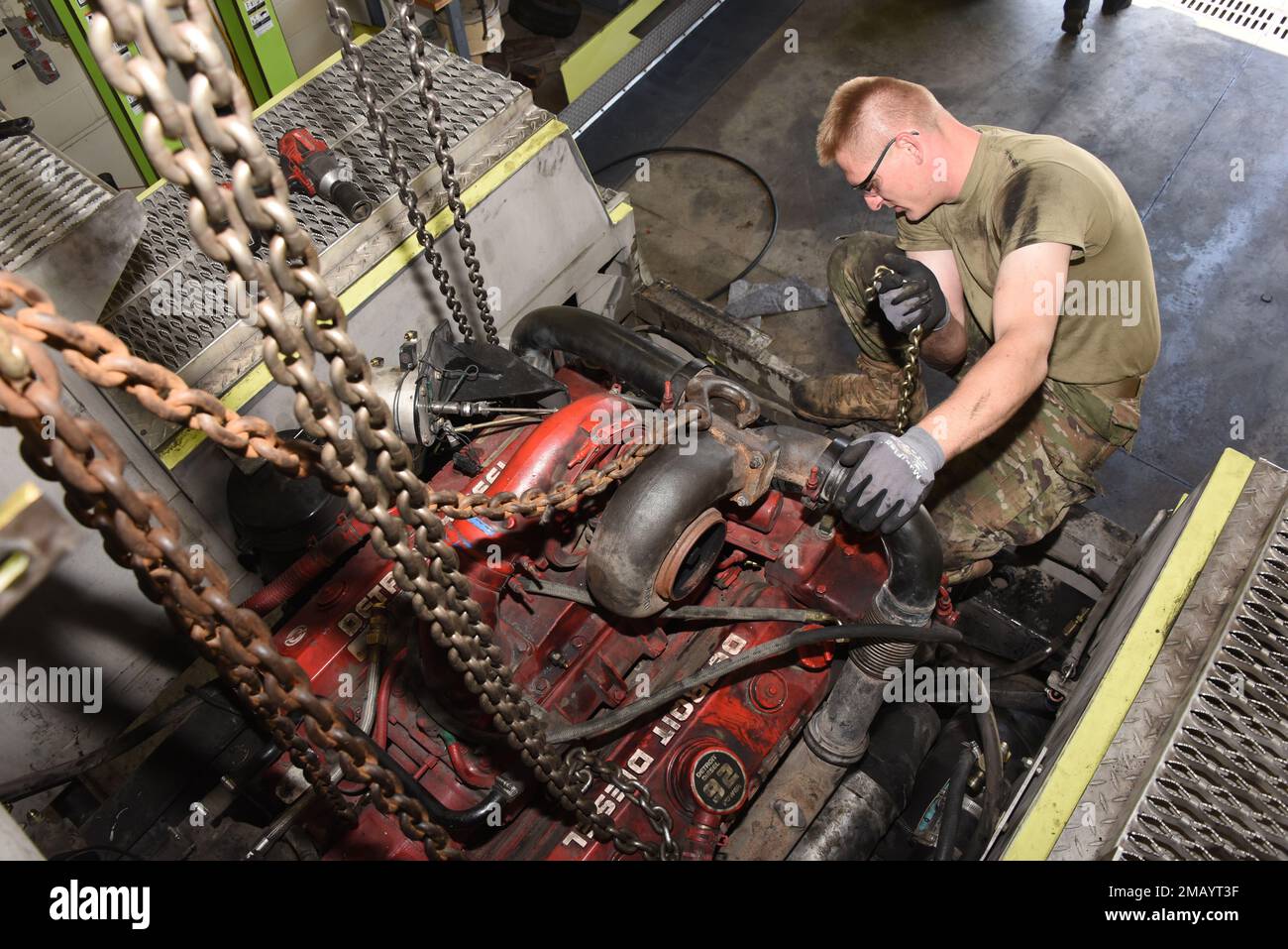 185th Air Refueling Wing vehicle mechanic Technical Sgt. Jason Lammers works to remove an 8 cylinder Detroit Diesel engine from the rear of a 1996 Teledyne P23 “Crash Truck” at the 185th Air Refueling Wing vehicle maintenance shop in Sioux City, Iowa on June 8, 2022. 185th ARW mechanics are overhauling the engine because it had developed an internal coolant leak.    U.S. Air National Guard photo Senior Master Sgt. Vincent De Groot Stock Photo