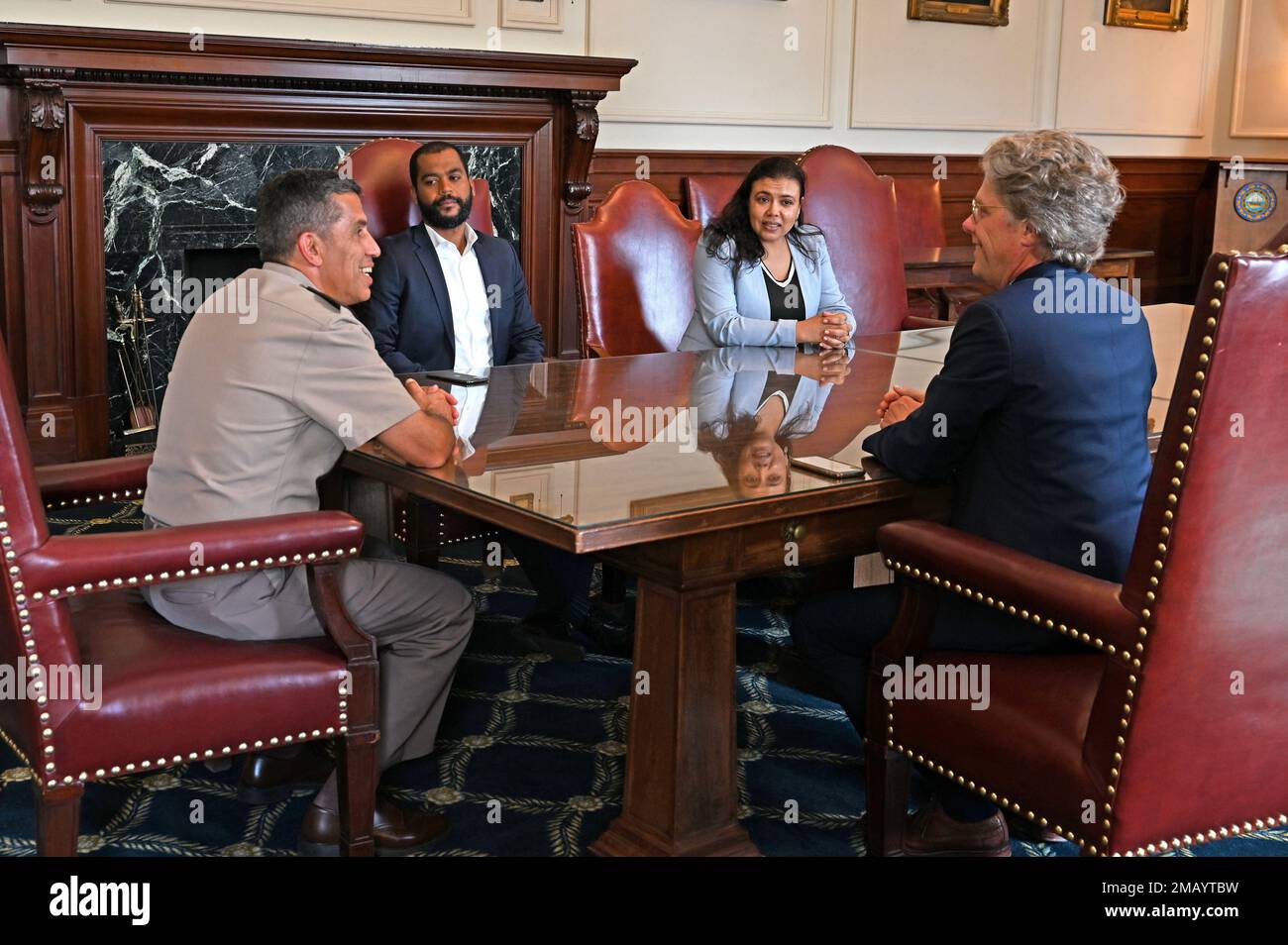 From left, Maj. Gen. David Mikolaities, New Hampshire adjutant general; Dr. Harold Tavares, Cabo Verde prime minister's chief of staff; Janine Lélis, Cabo Verde minister of defense; and Commissioner Taylor Caswell, New Hampshire Business and Economic Affairs; meet at the New Hampshire State House on June 8, 2022, in Concord. The New Hampshire National Guard hosted Lélis and delegates from the Republic of Cabo Verde, an African archipelagic country, June 8 – 10 for a State Partnership Program workshop. The Department of Defense program links state National Guards and foreign countries to facili Stock Photo