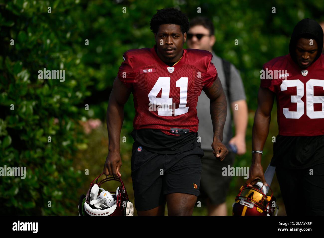 Washington Commanders linebacker Tre Walker makes his way to the field