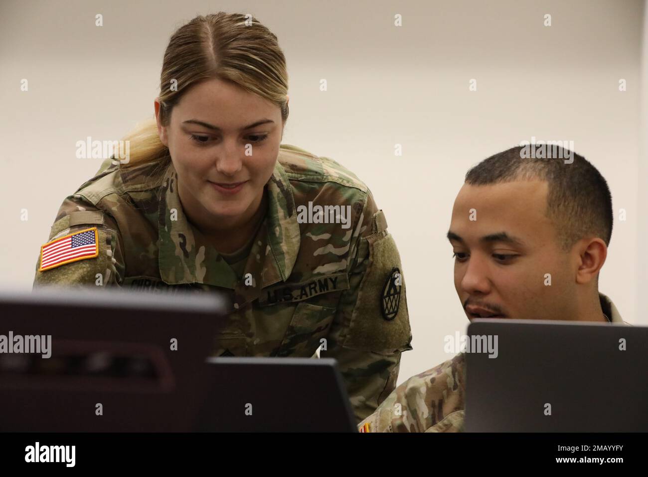 Sgt. Azaria Christian, the lead digital forensics instructor for Cyber Shield 2022, answers questions from Spc. Adrian Ramirez, an information technology specialist from her unit. Both serve with the North Carolina Army National Guard's 295th Signal Company. This is the 10th annual Cyber Shield event and is being held at the Army National Guard's Professional Education Center on Camp Robinson, North Little Rock, Arkansas, June 5-17. Cyber Shield 2022 is the DOD’s largest unclassified cyber security exercise working with multiple military branches and inter-agencies to collaborate in continuall Stock Photo