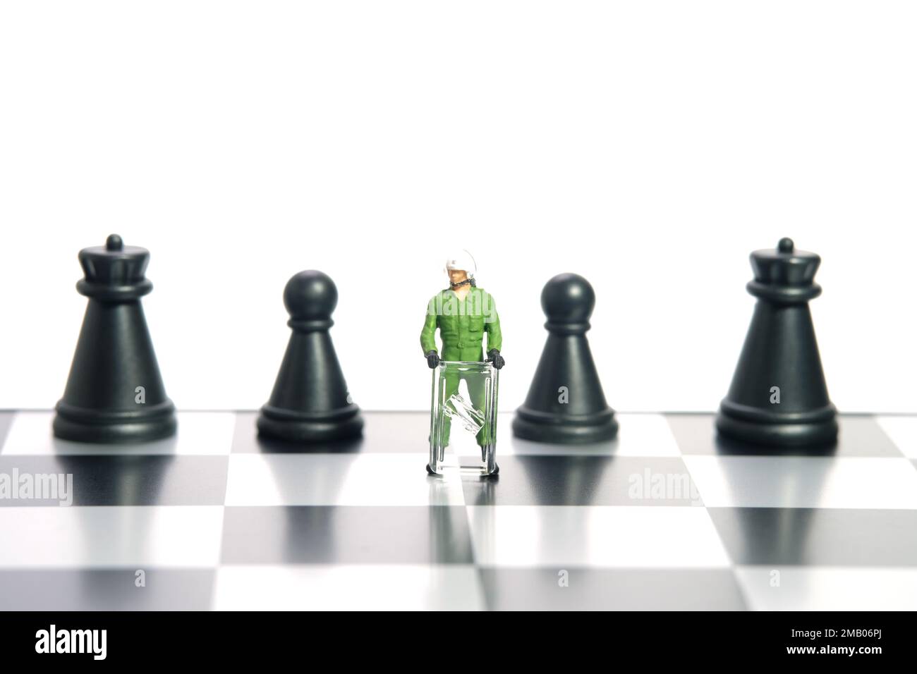Miniature people toy figure photography. Protection strategy concept. A military anti riot armored army standing above chessboard. Isolated on white b Stock Photo