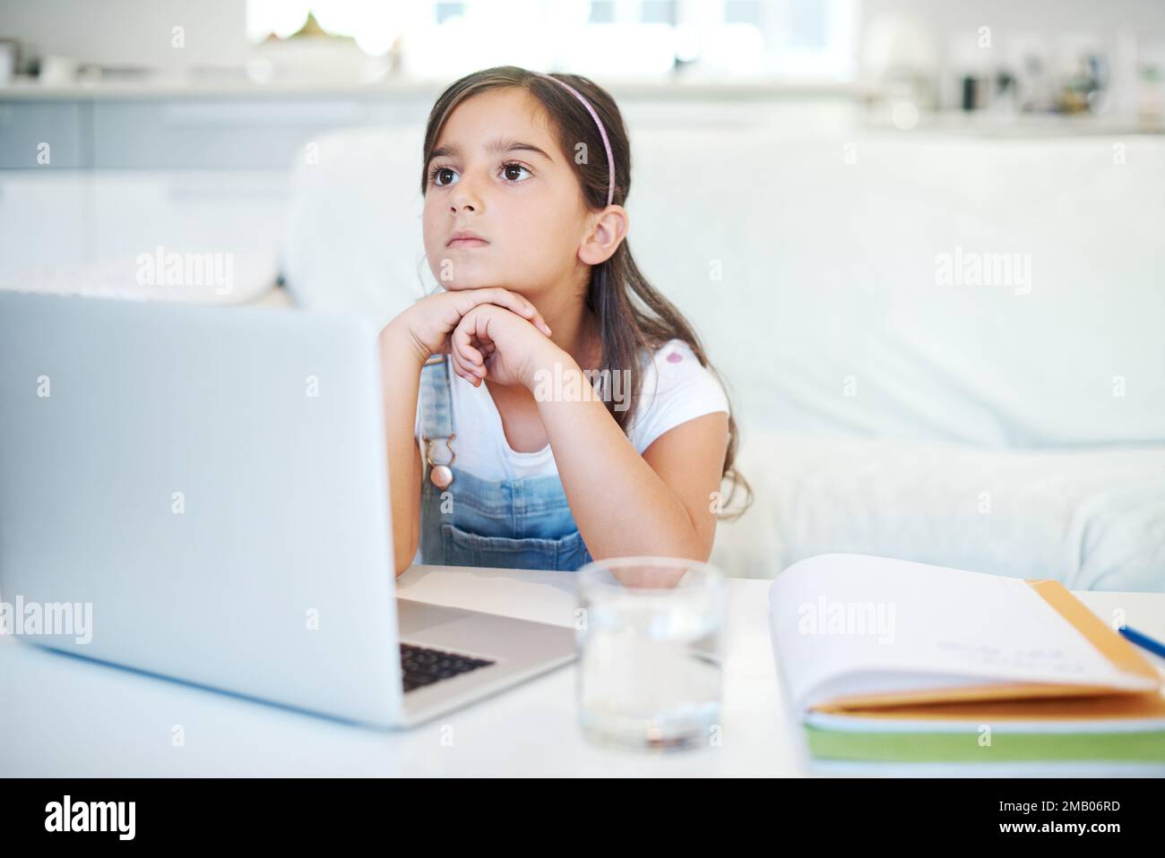 Could I not be a toddler forever. a little girl using a laptop at home. Stock Photo