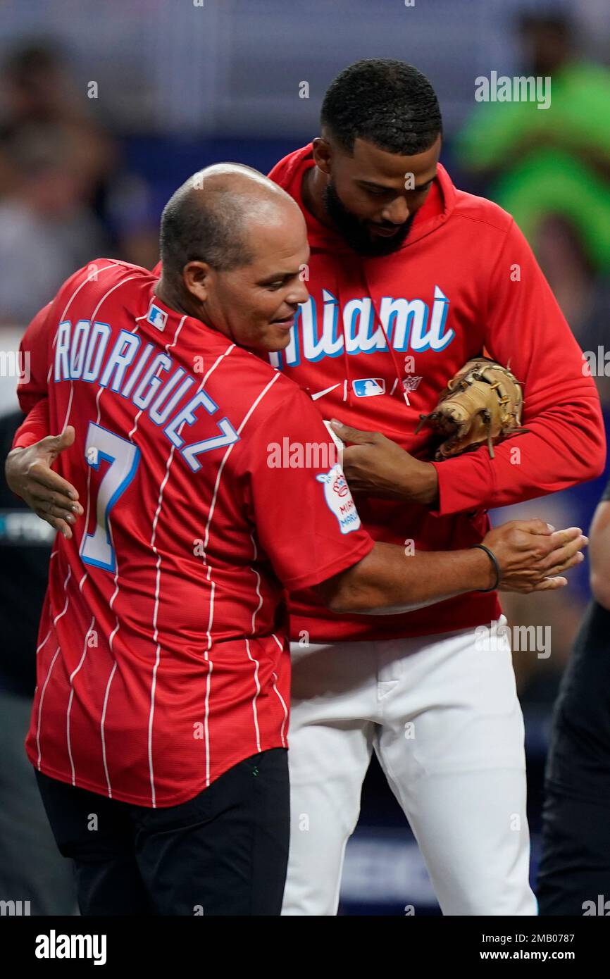 Baseball Hall of Famer Ivan Pudge Rodriguez, foreground, hugs Miami  Marlins pitcher Sandy Alcantara after Rodriguez threw out a ceremonial  first pitch before the start of a baseball game between the Marlins