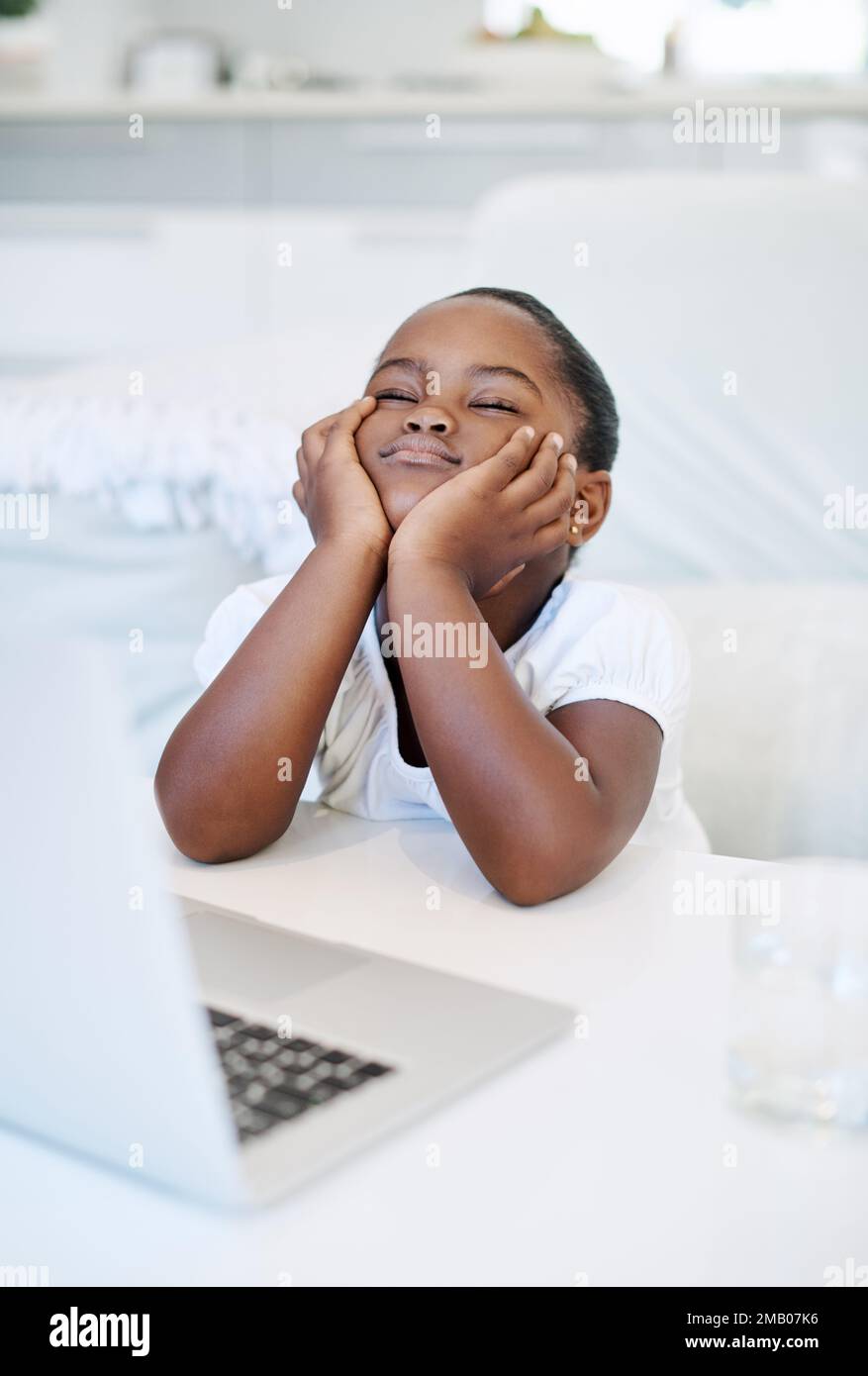 Do I have to do school today. a little girl looking bored at home. Stock Photo
