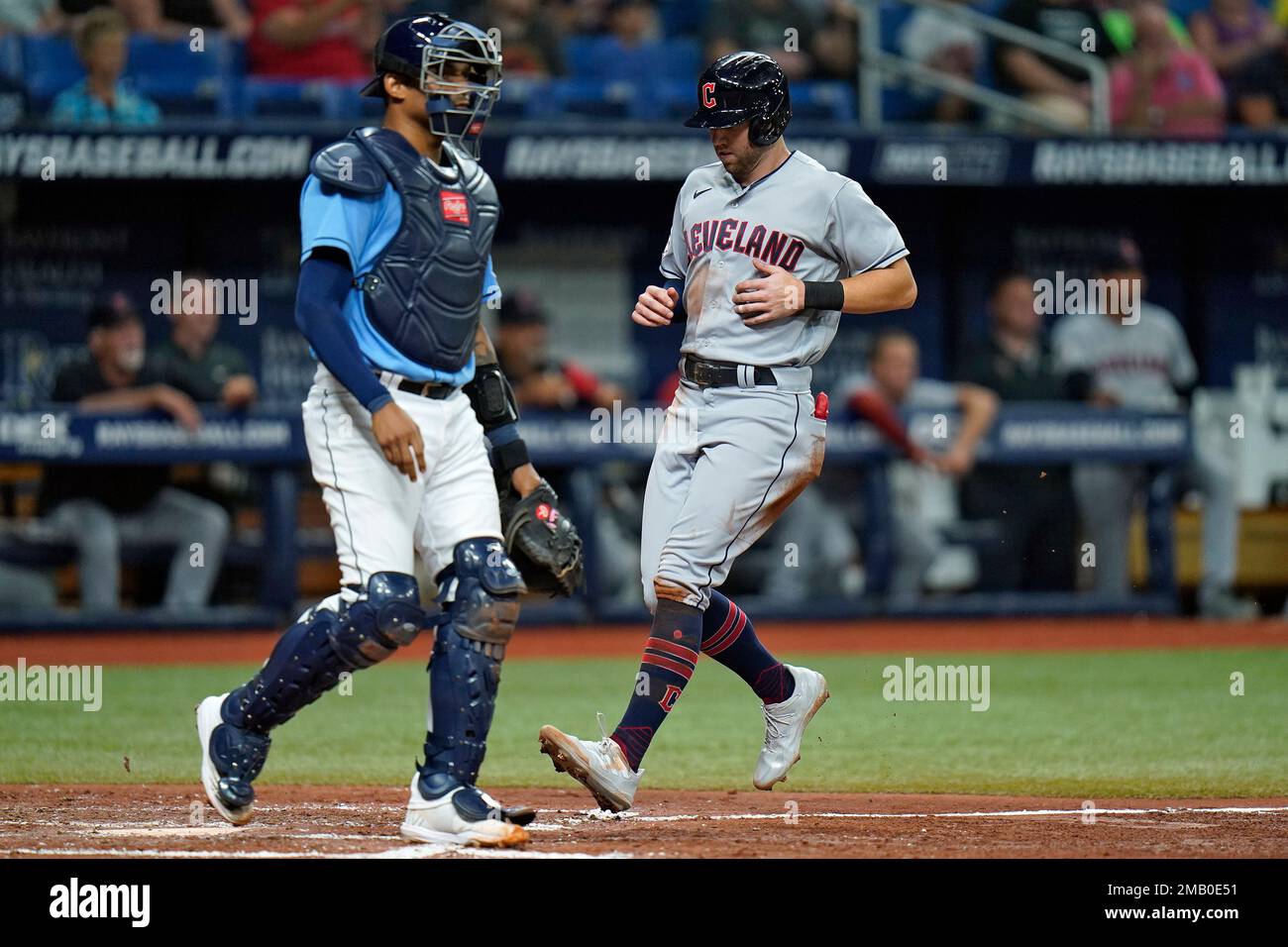 Cleveland Guardians' Owen Miller, right, scores in front of Tampa Bay Rays  first baseman Christian Bethancourt on an RBI double by Andres Gimenez off  Tampa Bay Rays starting pitcher Jeffrey Springs during