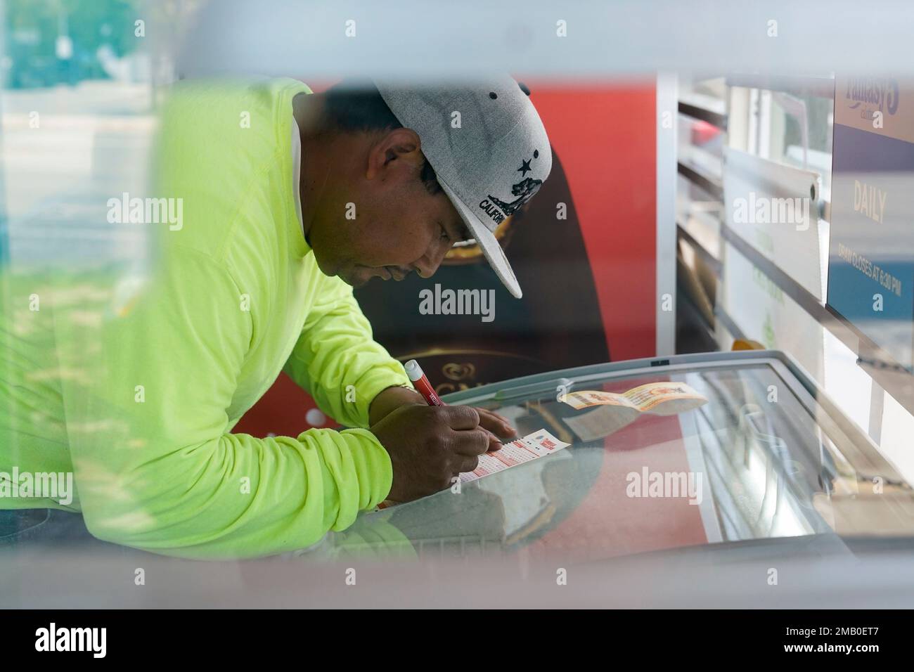 Rogelio Ramírez selects numbers to play before buying Mega Millions