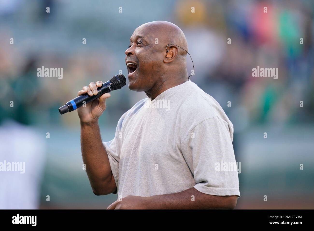 Tony Lindsay sings the national anthem before a baseball game between