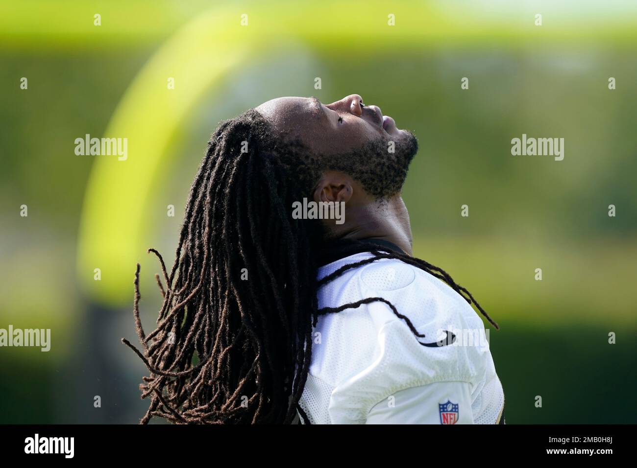 New Orleans Saints running back Alvin Kamara flips his hair back to put ...