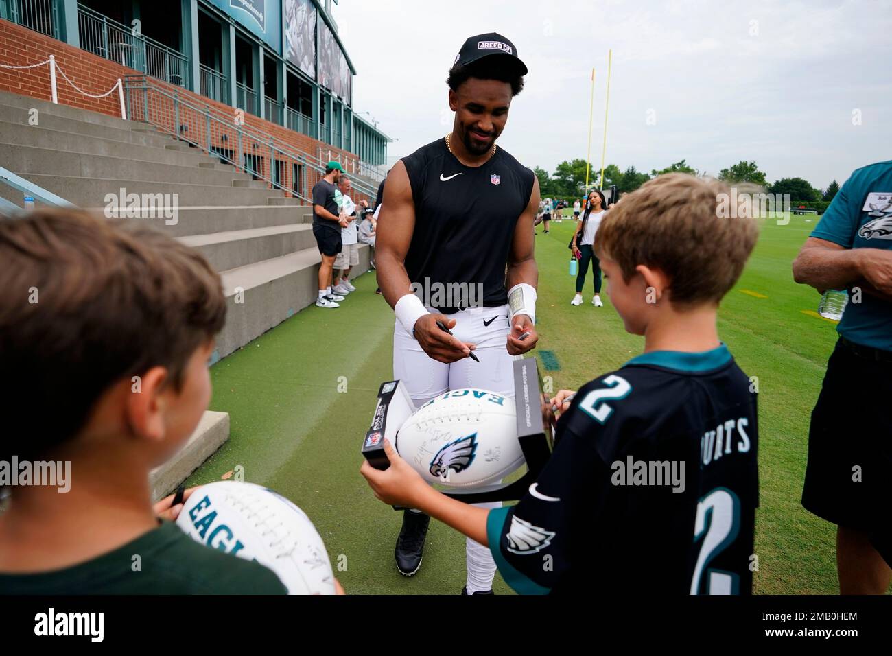 Member of the US military holds up the signed practice worm jersey of  Philadelphia Eagles quarterback Jalen Hurts for the Back Together  Saturday during practice at NFL football training camp, Saturday, July