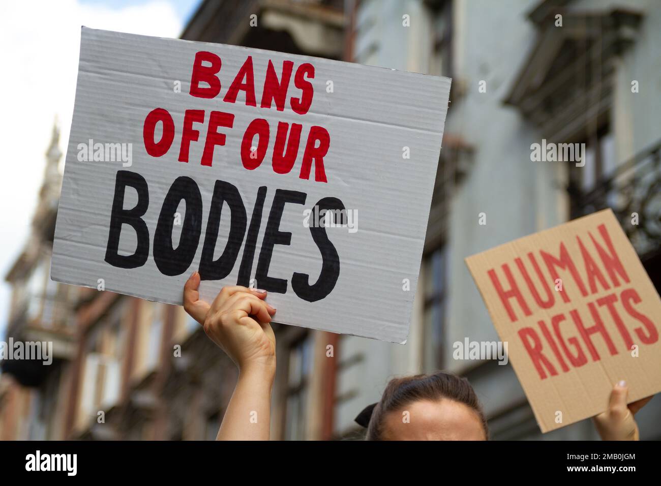 Protesters holding signs Bans Off Our Bodies and Human rights. People with placards supporting abortion rights at protest rally demonstration. Stock Photo