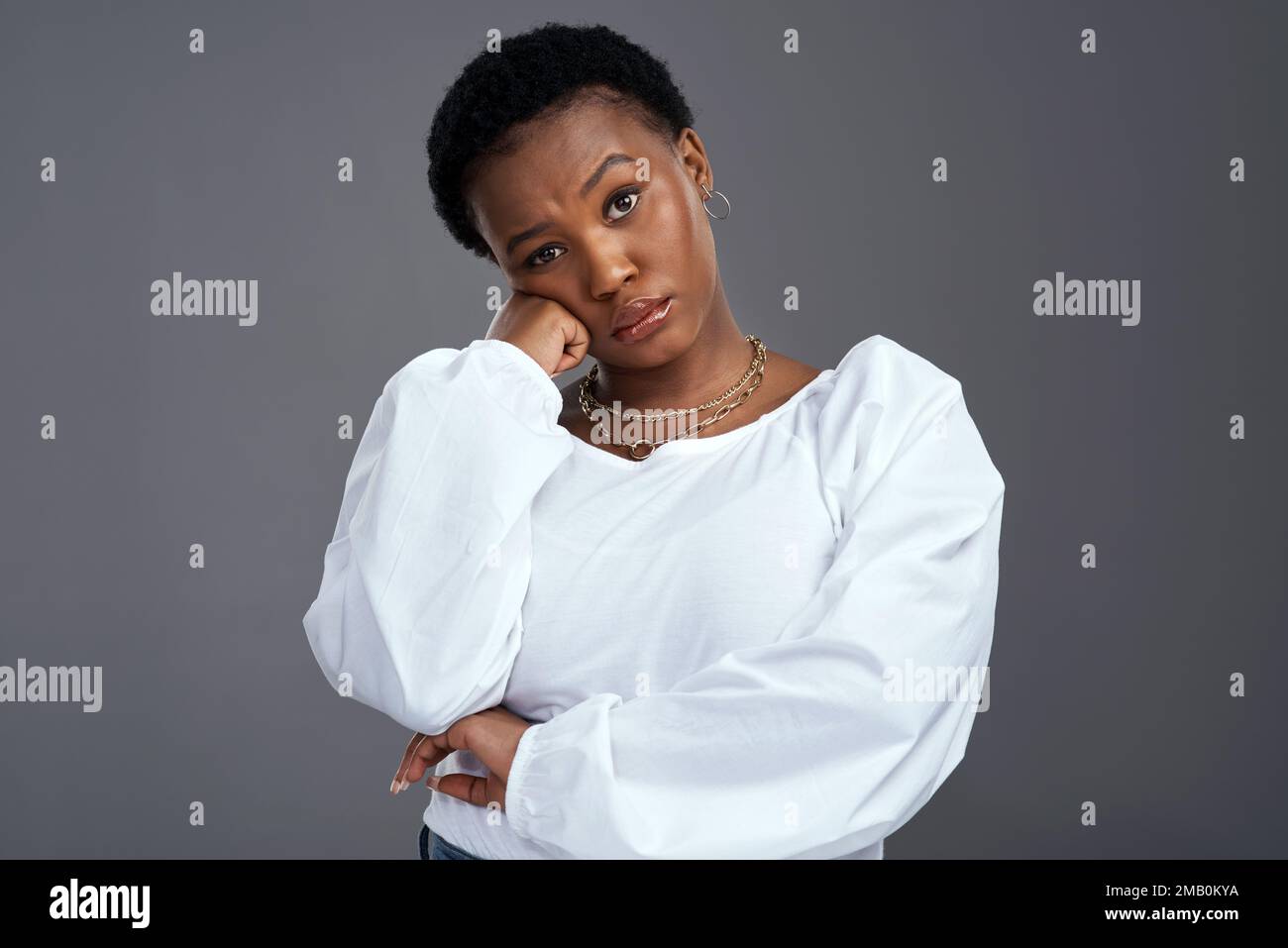 Im tired of the excused. a young woman looking serious while posing against a grey background. Stock Photo