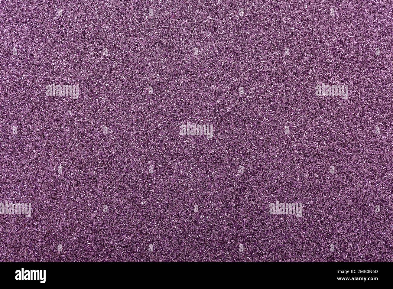 This image shows a macro abstract background of sparkling purple glitter texture surface. Stock Photo